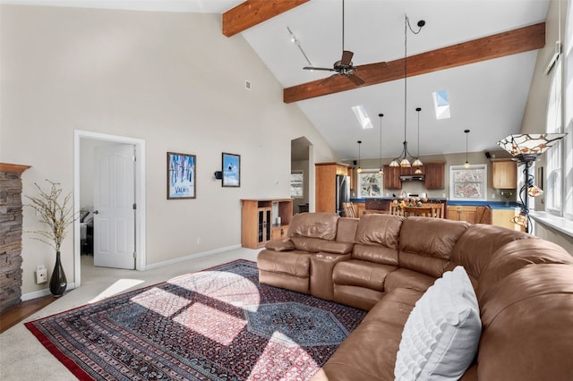 481 Marmot Cir, Silverthorne, CO 80498 - living room featuring beamed ceiling, high vaulted ceiling, a ceiling fan, baseboards, and a skylight