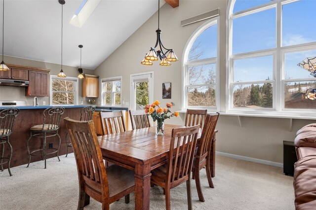 481 Marmot Cir, Silverthorne, CO 80498 - dining area featuring baseboards, high vaulted ceiling, a skylight, and light carpet