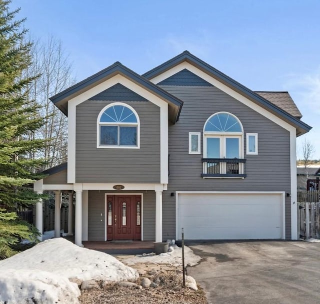481 Marmot Cir, Silverthorne, CO 80498 - view of front facade with driveway, a garage, covered porch, and fence