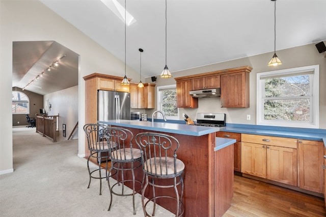 481 Marmot Cir, Silverthorne, CO 80498 - kitchen with a sink, under cabinet range hood, stainless steel electric range oven, a breakfast bar area, and lofted ceiling