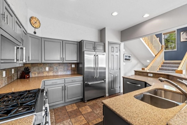2840 Kitzbuhel Ct Unit 2, Steamboat Springs, CO 80487 - kitchen with stainless steel appliances, gray cabinets, a sink, decorative backsplash, and recessed lighting