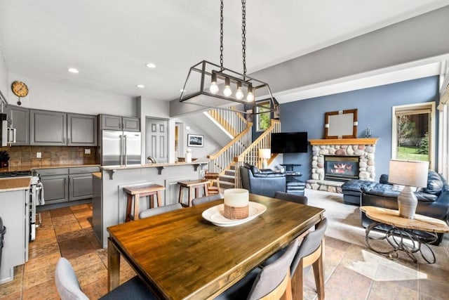 2840 Kitzbuhel Ct Unit 2, Steamboat Springs, CO 80487 - dining area with stairs, a fireplace, and recessed lighting