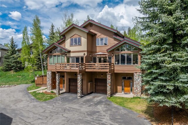 2840 Kitzbuhel Ct Unit 2, Steamboat Springs, CO 80487 - view of front of home featuring driveway, a garage, and stone siding
