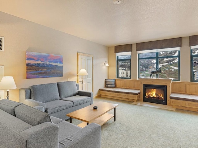 2300 Mt Werner Cir Unit 226/227Qiv, Steamboat Springs, CO 80487 - carpeted living room with a glass covered fireplace and a textured ceiling