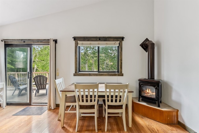 336 N Chipmunk Cir, Silverthorne, CO 80498 - dining space featuring lofted ceiling, wood finished floors, a wood stove, and plenty of natural light