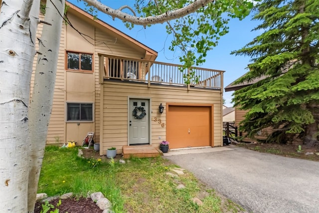 336 N Chipmunk Cir, Silverthorne, CO 80498 - view of front of home featuring a balcony, asphalt driveway, and an attached garage
