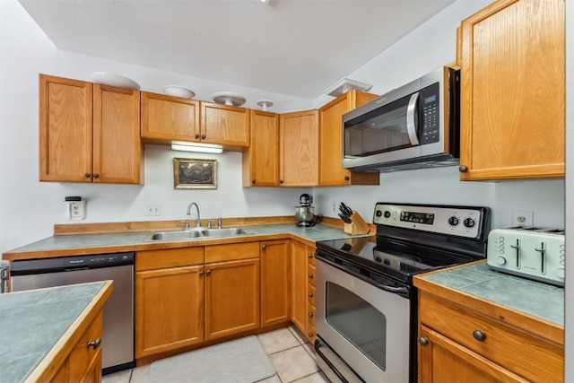 336 N Chipmunk Cir, Silverthorne, CO 80498 - kitchen featuring appliances with stainless steel finishes, light tile patterned floors, and brown cabinetry