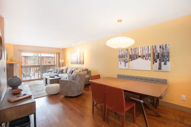 723 Meadow Creek Dr Unit B, Frisco, CO 80443 - dining area featuring wood finished floors and rail lighting