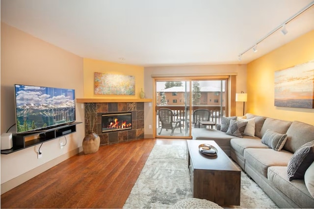 723 Meadow Creek Dr Unit B, Frisco, CO 80443 - living area with track lighting, wood finished floors, a fireplace, and baseboards