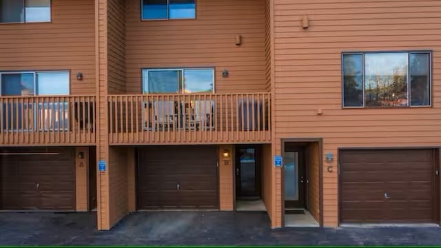 723 Meadow Creek Dr Unit B, Frisco, CO 80443 - rear view of property featuring a garage and a balcony