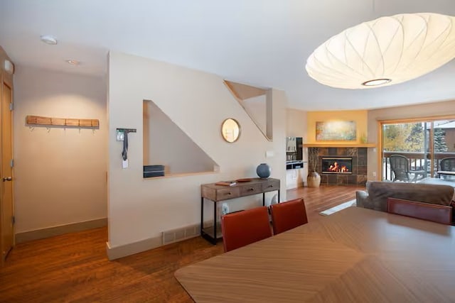 723 Meadow Creek Dr Unit B, Frisco, CO 80443 - dining area with wood finished floors, baseboards, and a tile fireplace