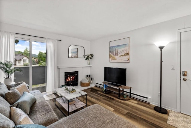 1300 Athens Plz Unit 2, Steamboat Springs, CO 80487 - living room featuring wood finished floors, a fireplace, and a baseboard heating unit