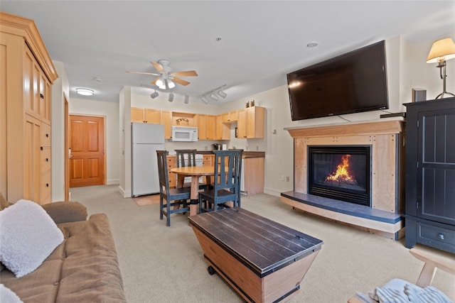 140 Ida Belle Dr Unit 8161, Keystone, CO 80435 - living room featuring light colored carpet, ceiling fan, rail lighting, a glass covered fireplace, and baseboards