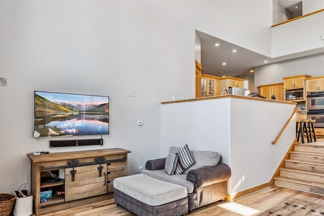 180 Emmett Lode Rd, Breckenridge, CO 80424 - living area featuring recessed lighting, a high ceiling, light wood finished floors, and stairs