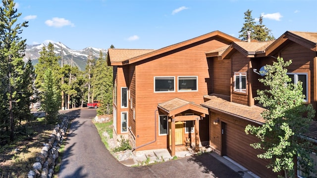 180 Emmett Lode Rd, Breckenridge, CO 80424 - view of front of property with an attached garage, driveway, a shingled roof, and a mountain view