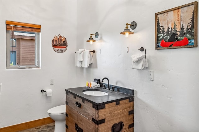180 Emmett Lode Rd, Breckenridge, CO 80424 - bathroom with baseboards, wood finished floors, vanity, and toilet