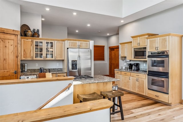 180 Emmett Lode Rd, Breckenridge, CO 80424 - kitchen featuring light brown cabinets, glass insert cabinets, light wood finished floors, appliances with stainless steel finishes, and recessed lighting
