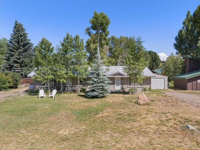 2646 Riverside Dr Unit A, Steamboat Springs, CO 80487 - view of front of house featuring driveway, a front yard, an attached garage, and a metal roof