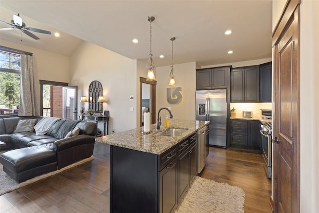 799 Independence Rd Unit 799, Keystone, CO 80435 - kitchen featuring stainless steel appliances, open floor plan, light stone countertops, dark wood-style flooring, and a ceiling fan
