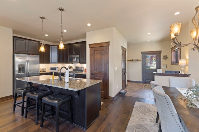 799 Independence Rd Unit 799, Keystone, CO 80435 - kitchen featuring stainless steel appliances, dark brown cabinetry, light stone counters, dark wood-style floors, and recessed lighting