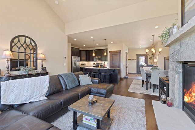 799 Independence Rd Unit 799, Keystone, CO 80435 - living area with a chandelier, dark wood-type flooring, a glass covered fireplace, lofted ceiling, and recessed lighting