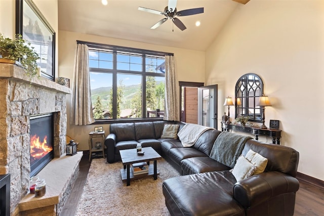 799 Independence Rd Unit 799, Keystone, CO 80435 - living area with a stone fireplace, wood finished floors, ceiling fan, high vaulted ceiling, and a mountain view