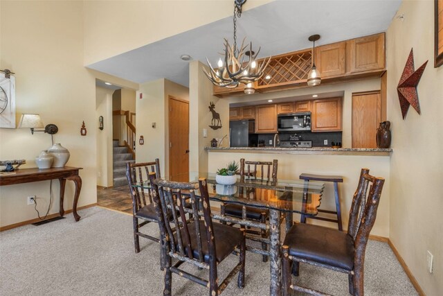 1660 Lakeview Ter Unit 306F, Frisco, CO 80443 - dining space with carpet, a chandelier, baseboards, and stairs