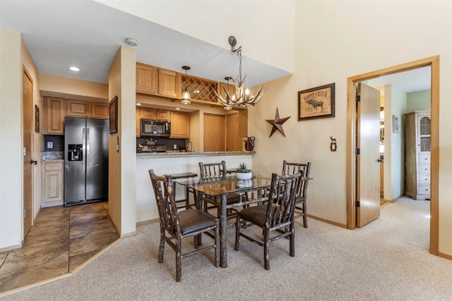 1660 Lakeview Ter Unit 306F, Frisco, CO 80443 - dining room with light colored carpet, a chandelier, and baseboards