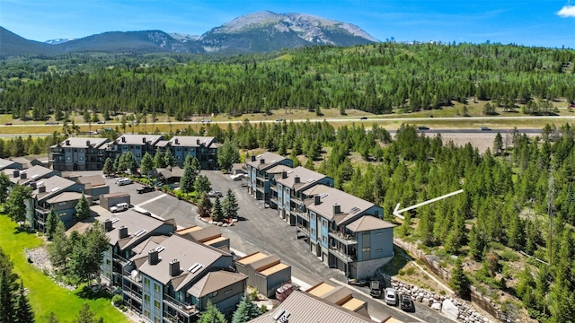 1660 Lakeview Ter Unit 306F, Frisco, CO 80443 - drone / aerial view of a heavily wooded area and a mountainous background