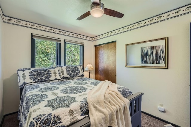 carpeted bedroom with a ceiling fan, baseboards, and a closet