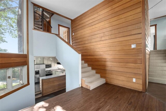 2495/2497 Val Disere Cir, Steamboat Springs, CO 80487 - stairs featuring wood finished floors, wood walls, and healthy amount of natural light