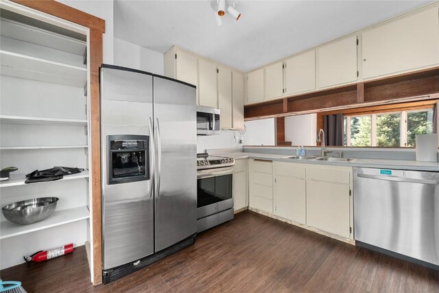 2495/2497 Val Disere Cir, Steamboat Springs, CO 80487 - kitchen with stainless steel appliances, cream cabinetry, dark wood-style flooring, and light countertops