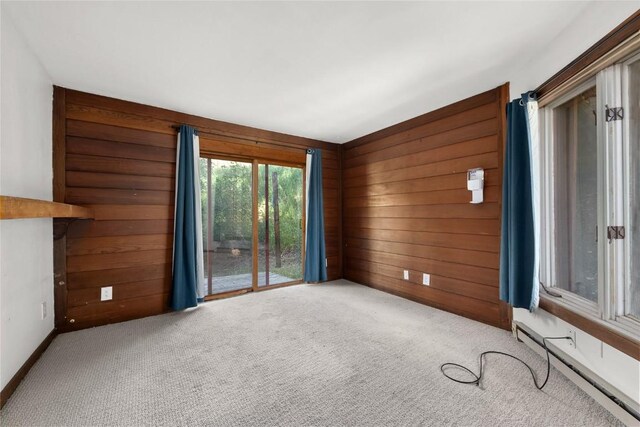 2495/2497 Val Disere Cir, Steamboat Springs, CO 80487 - carpeted empty room with wood walls and a baseboard radiator