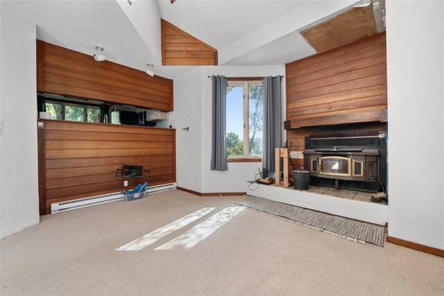 2495/2497 Val Disere Cir, Steamboat Springs, CO 80487 - unfurnished living room with a wood stove, carpet flooring, vaulted ceiling, and baseboard heating