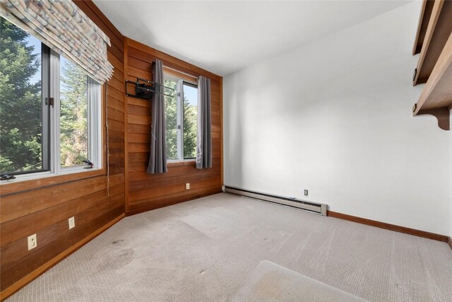 2495/2497 Val Disere Cir, Steamboat Springs, CO 80487 - carpeted spare room with a baseboard radiator and wood walls