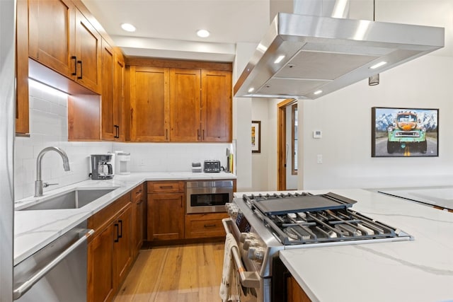 317 Granite St Unit 3, Frisco, CO 80443 - kitchen with extractor fan, stainless steel appliances, a sink, light stone counters, and backsplash