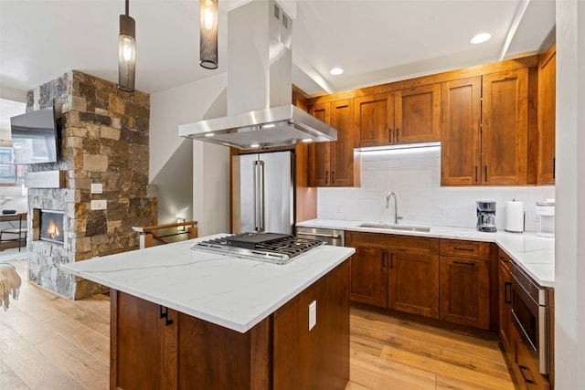 317 Granite St Unit 3, Frisco, CO 80443 - kitchen featuring a sink, island range hood, appliances with stainless steel finishes, light wood-type flooring, and a kitchen island