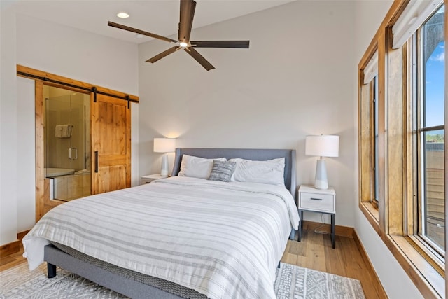317 Granite St Unit 3, Frisco, CO 80443 - bedroom featuring a barn door, wood finished floors, baseboards, ceiling fan, and recessed lighting