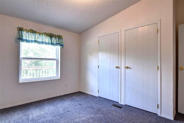 605 Lamb Mountain Rd, Fairplay, CO 80440 - unfurnished bedroom featuring a textured ceiling, carpet flooring, and lofted ceiling