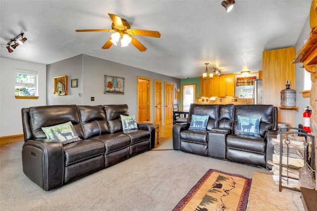 216 Ambush Ln, Jefferson, CO 80456 - living area featuring healthy amount of natural light, carpet, ceiling fan, and a chandelier