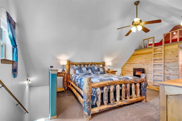 216 Ambush Ln, Jefferson, CO 80456 - bedroom with vaulted ceiling, carpet, wooden walls, and a ceiling fan