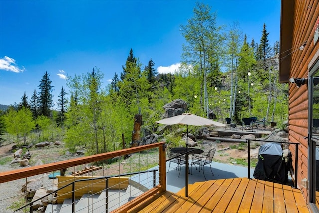 216 Ambush Ln, Jefferson, CO 80456 - wooden deck with outdoor dining area and a grill