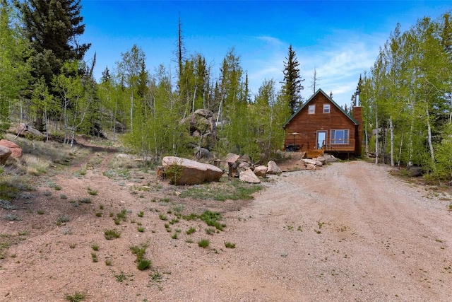 216 Ambush Ln, Jefferson, CO 80456 - view of property exterior with driveway and a chimney