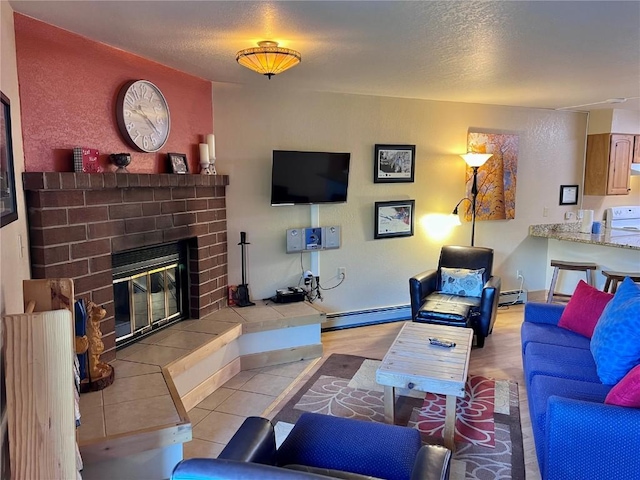 living area with a baseboard heating unit, a textured ceiling, a fireplace, and baseboard heating