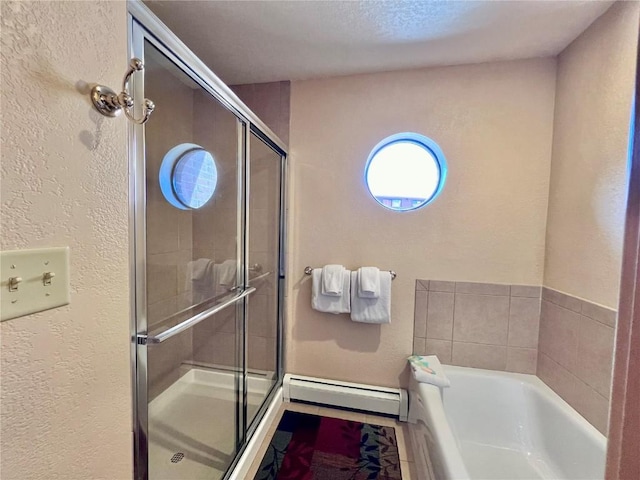 bathroom featuring baseboard heating, a garden tub, a textured wall, and a stall shower