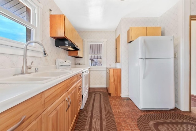 401 Moffat Ave, Oak Creek, CO 80467 - kitchen with white appliances, under cabinet range hood, wallpapered walls, a sink, and light countertops