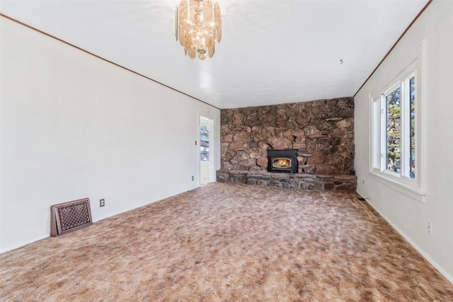 401 Moffat Ave, Oak Creek, CO 80467 - unfurnished living room featuring carpet floors, a chandelier, and a wood stove