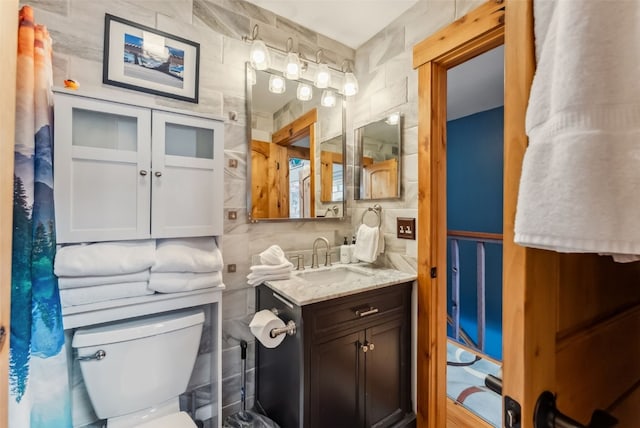 876 Broken Lance Dr Unit 876, Breckenridge, CO 80424 - bathroom with tile walls, vanity, and toilet