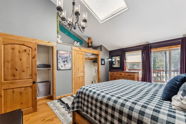 876 Broken Lance Dr Unit 876, Breckenridge, CO 80424 - bedroom with vaulted ceiling, a chandelier, light wood-type flooring, and access to exterior