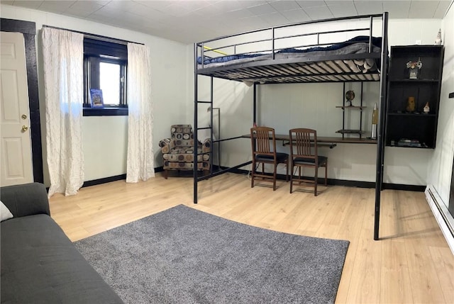 205 Arthur Ave, Oak Creek, CO 80467 - bedroom featuring wood finished floors and a baseboard heating unit